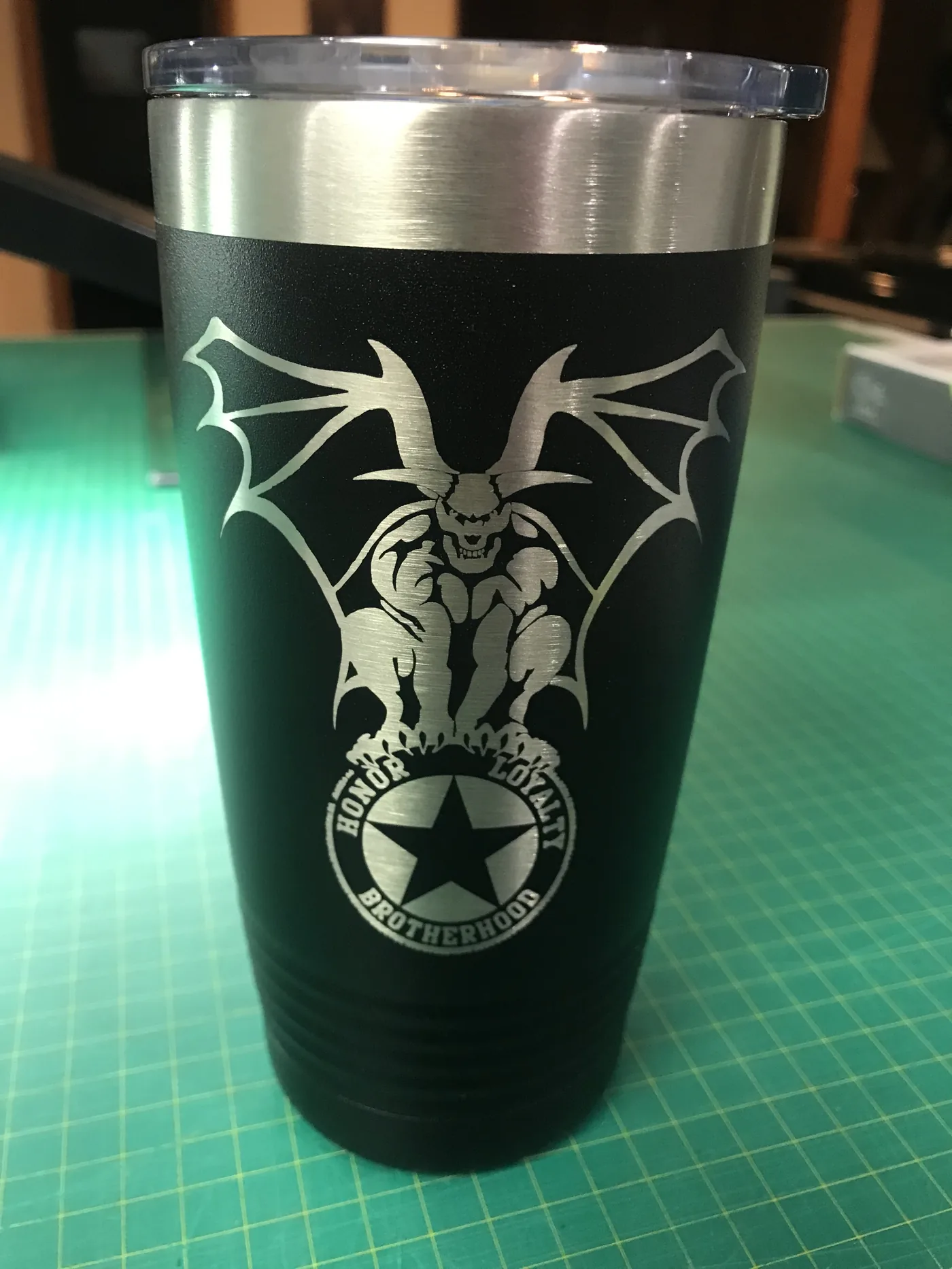 Black tumbler engraved with a brotherhood emblem and crest