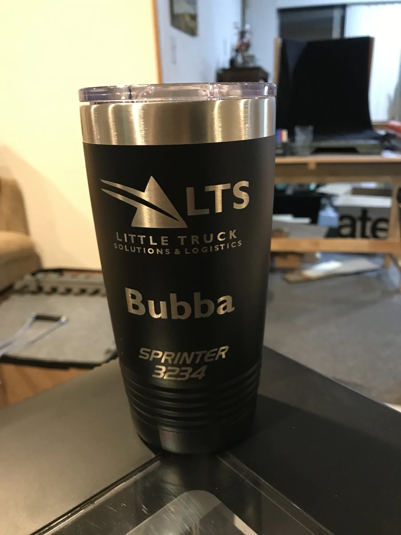 Black tumbler engraved with the Little Truck Solutions and Logistics logo and a driver name