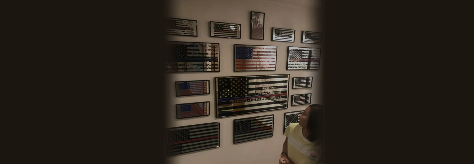 Wall display of framed mirrored tribute flags