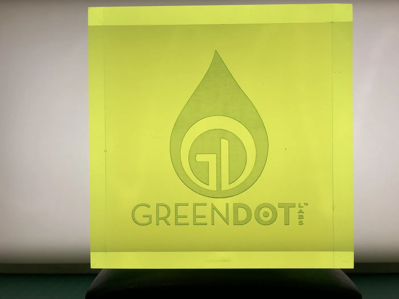 GreenDot corporate logo etched into a colored glass panel