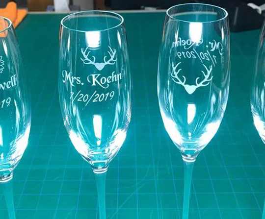 Champagne flutes etched with the couple&rsquo;s name and wedding date